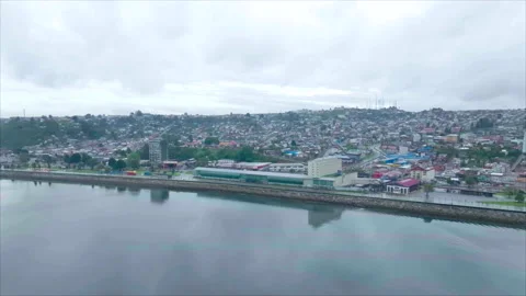 Puerto Montt's building reflections with light right to left tracking Stock Footage 340994619