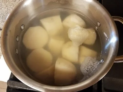 Puerto Rican root vegetable in pot of water Stock Photos