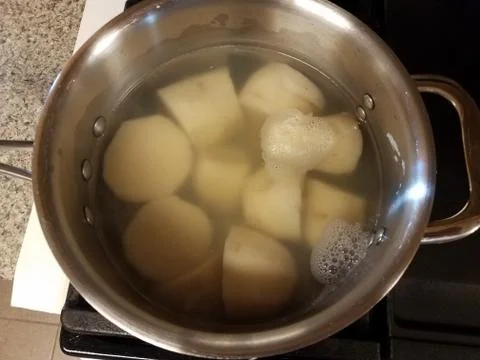 Puerto Rican root vegetable in pot of water Stock Photos