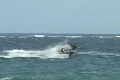 Puerto Rico - Jetski and kitesurfer playing chicken at sunset Footage