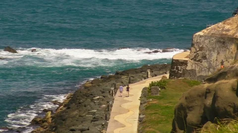 Puerto Rico - People on Sidewalk along the waterfront below El Morro Fortress Stock Footage