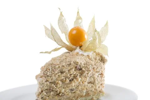 Puff cake with walnuts and physalis. Stock Photos