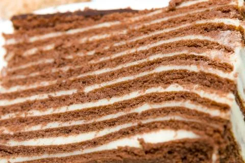 Puff chocolate sponge cake with nuts Chocolate puff cake. Stock Photos