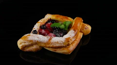 Puff pastry with berries on the black background rotating (loop) Stock Footage 55641398
