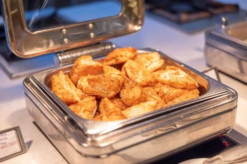 Puff pastry in Chafing Dish on buffet table in restaurant Stock Photos