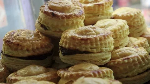 Puff pastry cups macro video highlighting layered sides and rich savory Stock Footage 338164522