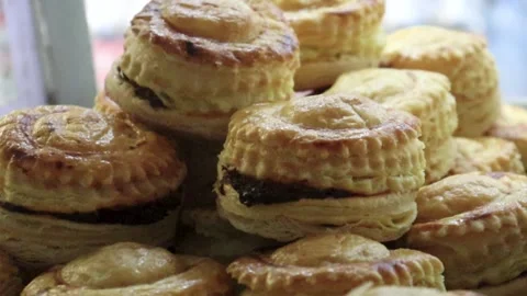 Puff pastry cups macro video highlighting layered sides and rich savory Stock Footage 338164574