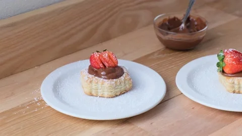 Puff pastry filled with chocolate pudding and strawberries. Stock Footage 143630364