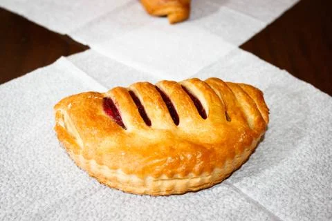 Puff pastry with jam on the table, on a white napkin. 스톡 사진