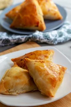 Puff pastry triangles filled minced meat, onion and spices Stock Photos