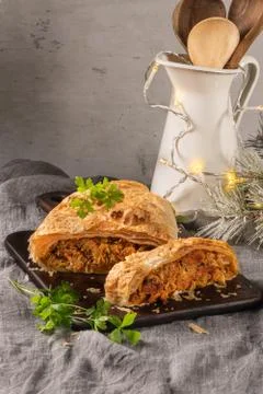 Puff pastry vegetable roll on kitchen table with christmas decorated Stock Photos