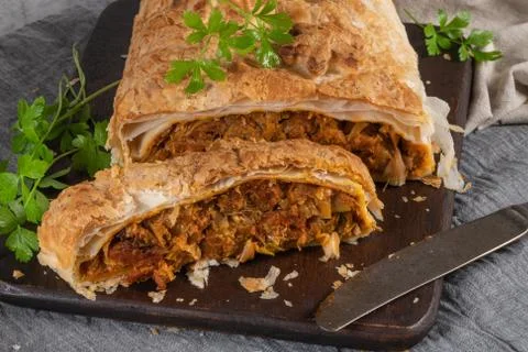 Puff pastry vegetable roll on kitchen table with christmas decorated Stock Photos