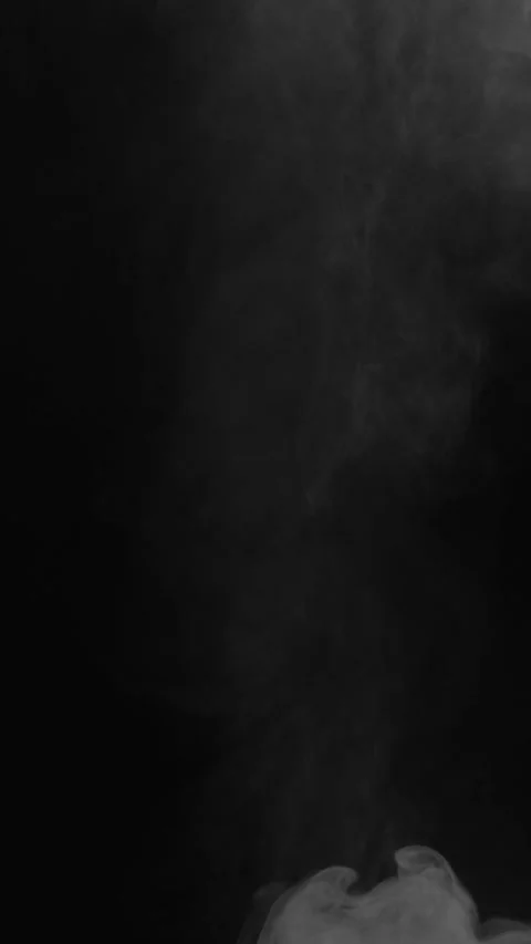 Puff of white smoke enters frame on black background, vertical format Stock Footage 340131212