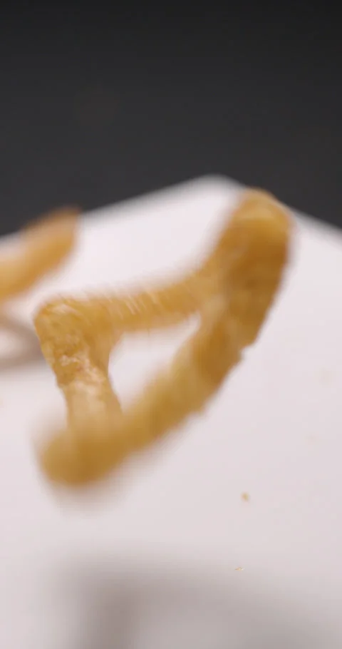 Puffed chips with paprika flavor falling slow motion, vertical view Stock Footage 280520101