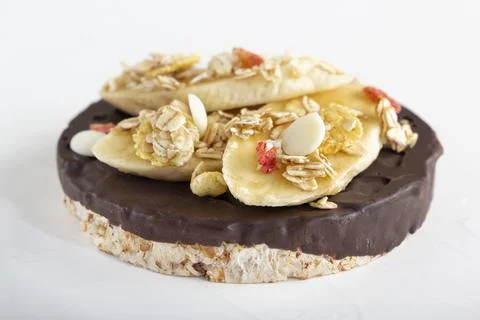 Puffed exploded wheat grains with chocolate glaze with muesli and cut banana Stock Photos