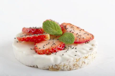 Puffed exploded wheat grains with white chocolate frosting with strawberries Stock Photos