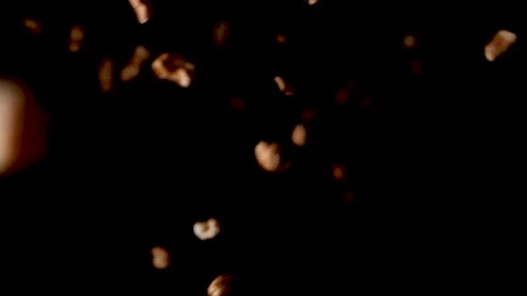 Puffed oat flakes flying down into black background in slow-motion. Video stock 153579195