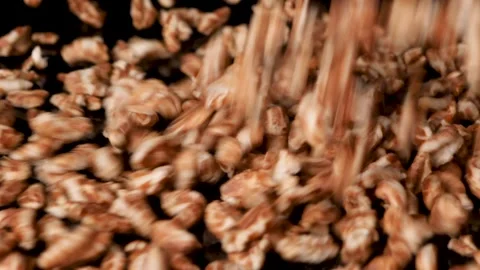 Puffed oats falling in slowmotion on isolated black background. Stock Footage 151883935