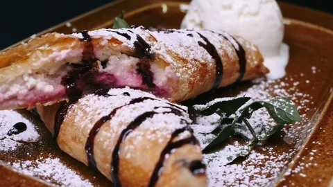 Puffed pie with tvrog stuffed with sweet jam decorated with mint and sweet powde Stock Footage 112062676