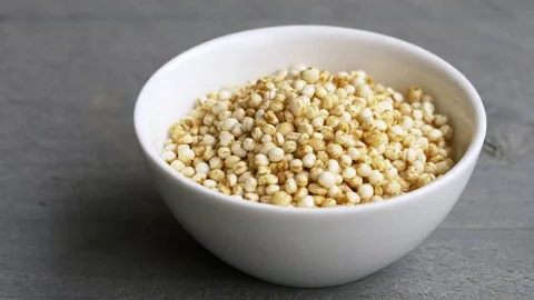 Puffed quinoa falling into a small bowl Stock Footage 69167594