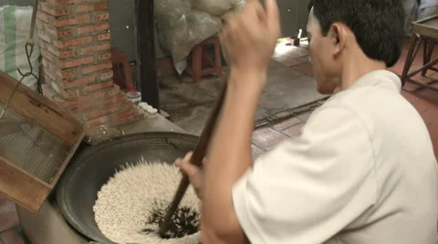 Puffed rice being separated from hot sand after being made Stock Footage 48146662