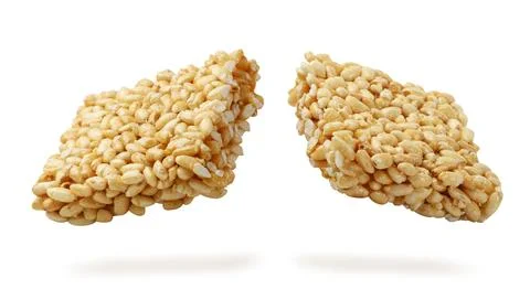 Puffed rice broken in half flies close-up on a white. Isolated Stock Photos