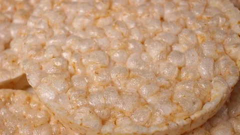 Puffed rice cakes rotating pattern macro texture background backdrop footage Stock Footage 91381250