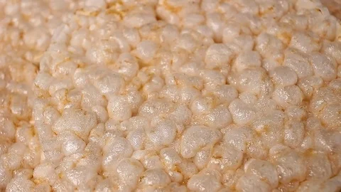 Puffed rice cakes rotating pattern macro texture background backdrop footage Stock Footage 91381326