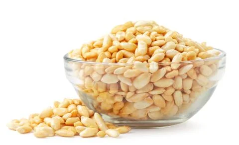 Puffed rice in a plate and scattered on a white background. Isolated Stock Photos