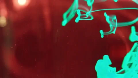 Puffs of multi-colored liquid ink paint flow in the liquid. 動画素材 193443743