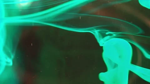 Puffs of multi-colored liquid ink paint flow in the liquid. Stock Footage 193446684