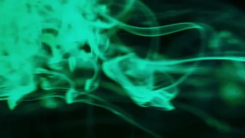 Puffs of multi-colored liquid ink paint flow in the liquid. Stock Footage 193448133