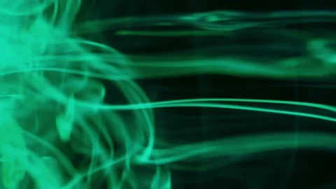 Puffs of multi-colored liquid ink paint flow in the liquid. Stock Footage 193449570