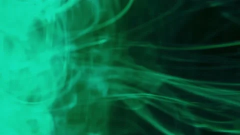 Puffs of multi-colored liquid ink paint flow in the liquid. Stock Footage 193452290