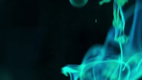 Puffs of multi-colored liquid ink paint flow in the liquid. Stock Footage 193455422