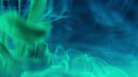 Puffs of multi-colored liquid ink paint flow in the liquid. Stock Footage 193456278