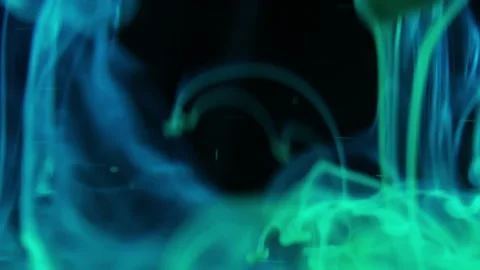 Puffs of multi-colored liquid ink paint flow in the liquid. Stock Footage 193459222