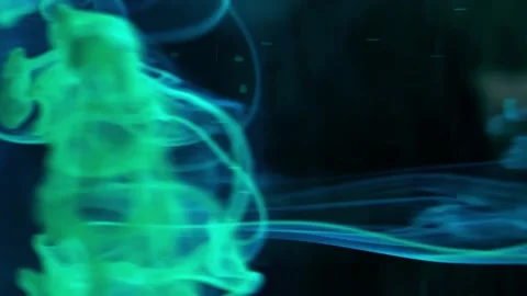 Puffs of multi-colored liquid ink paint flow in the liquid. Stock Footage 193462179