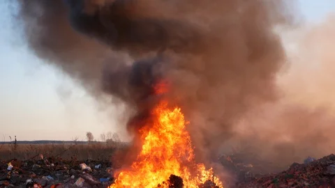 Puffs of smoke from the trash. burning garbage. concern for the environment. env Stock Footage 128278481