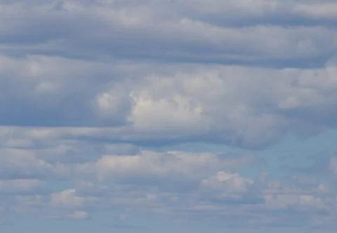 Puffy blue clouds Stock Photos