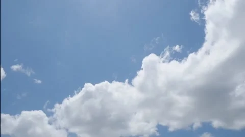 Puffy cloud on clear blue sky time lapse Stock Footage 155924535