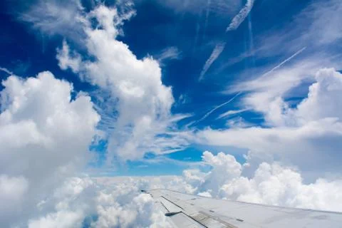Puffy Clouds on Blue Sky Background 库存照片