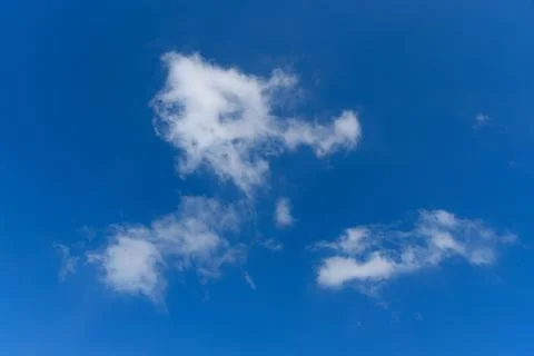 Puffy clouds on blue sky background Stock Photos