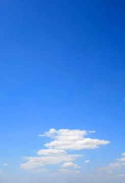 Puffy clouds on blue sky Stock Photos