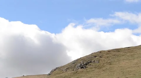Puffy Clouds Coming over the Ridge Stock Footage 46124712