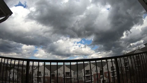 Puffy clouds float over the rooftops in Alexandria, Virginia, USA. Stock Footage 91338517