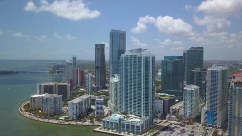 Puffy clouds flying left towards tip of downtown Miami skyline Stock Footage 88488849