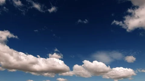 Puffy clouds mid day  - Real Time Stock Footage 100747082