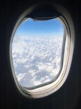 Puffy clouds outside the window Stock Photos