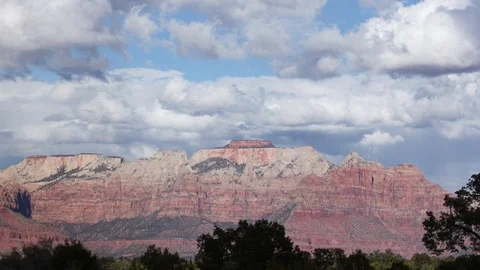 Puffy clouds over cliffs time lapse Stock Footage 98230605